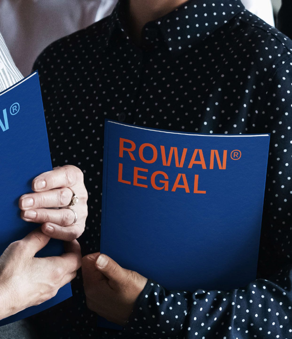 Rowan Legal two women holding Rowan Tax and Rowan Legal books with blue cover mobile